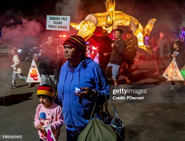lismore lantern parade 2022 people marching in free parade. indigenous group marches. - emergencies and disasters australia stock pictures, royalty-free photos & images
