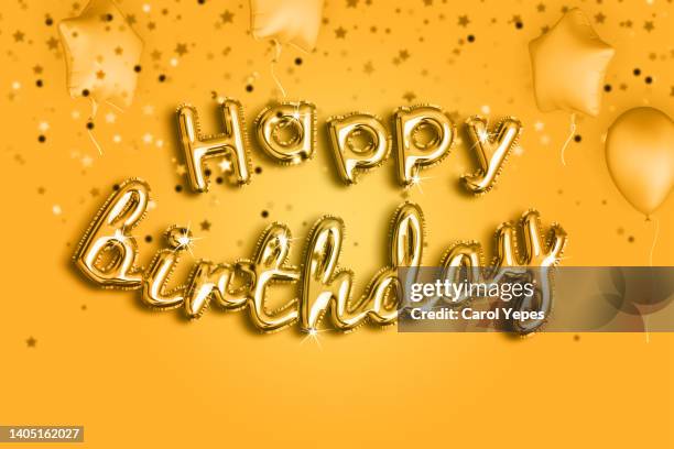 happy birthday in orange and yellow  foiled balloon - silver balloon imagens e fotografias de stock