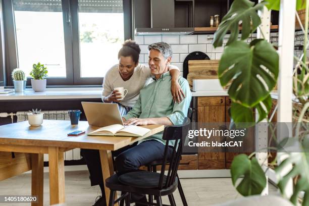 domestic life for mature couple. easy mornings and working from home - mature couple stock pictures, royalty-free photos & images