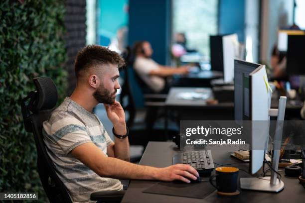 young programmer working in a joint office - sticky-notes-covering-computer-monitor stock pictures, royalty-free photos & images