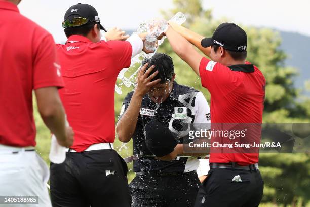 Minkyu Kim of South Korea is doused with water after his winning putt on the 18th green during The Open Qualifying Series, part of the Kolon Korea...