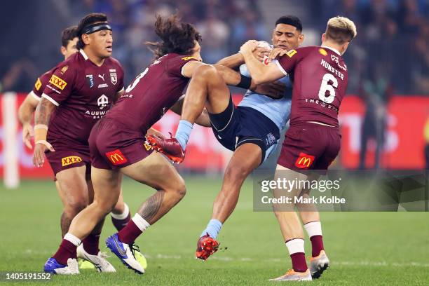 Daniel Tupou of the Blues is tackled during game two of the State of Origin series between New South Wales Blues and Queensland Maroons at Optus...