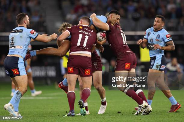 Daniel Tupou of the Blues is tackled during game two of the State of Origin series between New South Wales Blues and Queensland Maroons at Optus...