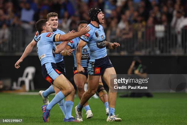 Matt Burton of the Blues celebrates with teammates after scoring a try during game two of the State of Origin series between New South Wales Blues...