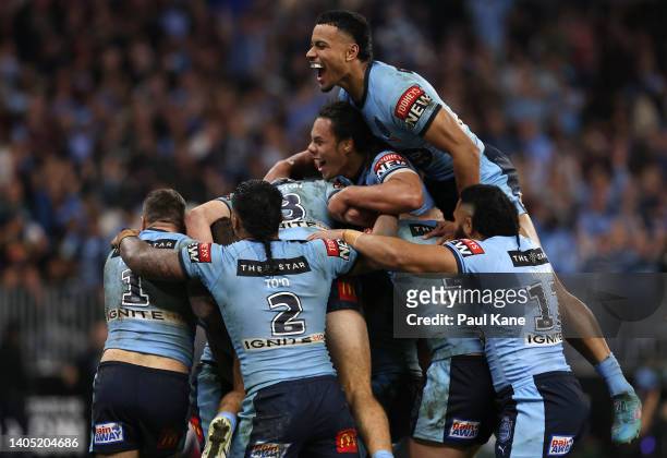 Nathan Cleary of the Blues celebrates with teammates after scoring a try during game two of the State of Origin series between New South Wales Blues...