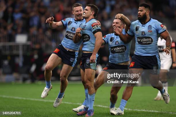 Nathan Cleary of the Blues celebrates with teammates after scoring a try during game two of the State of Origin series between New South Wales Blues...