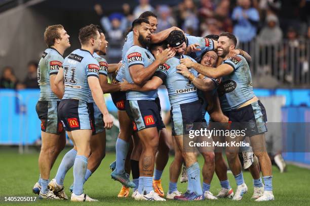 Nathan Cleary of the Blues celebrates with team mates after scoring his secon try during game two of the State of Origin series between New South...