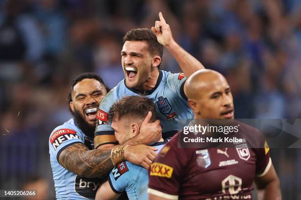 Angus Crichton of the Blues celebrates with Siosifa Talakai and Nathan Cleary after scoring a try during game two of the State of Origin series...