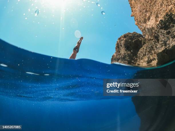 diving into the water from a cliff - cliff diving stock pictures, royalty-free photos & images