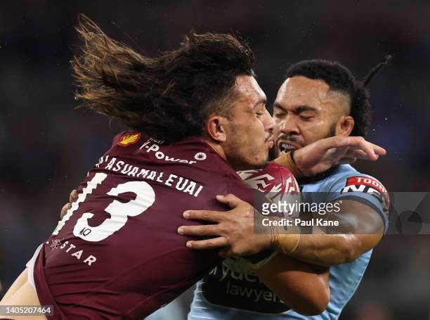 Tino Fa’asuamaleaui of the Maroons is tackled by Siosifa Talakai of the Blues during game two of the State of Origin series between New South Wales...