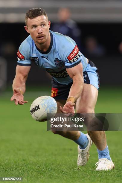 Damien Cook of the Blues passes the ball during game two of the State of Origin series between New South Wales Blues and Queensland Maroons at Optus...