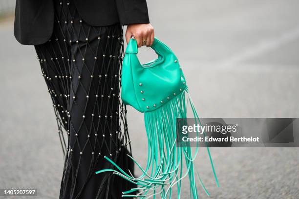 Guest wears a black satin with embroidered fishnet with silver pearls and fringed details V-neck / jumpsuit, a black blazer jacket, a green shiny...