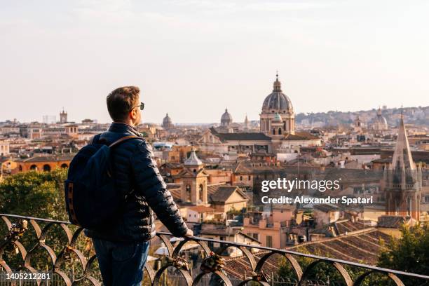 rear view of a man looking at rome skyline from above, italy - city breaks winter stock pictures, royalty-free photos & images