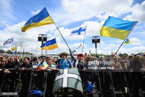 Festival-goers wave flags as Ukrainian group Dakhabrakha performs on the Pyramid Stage during day five of Glastonbury Festival at Worthy Farm, Pilton...