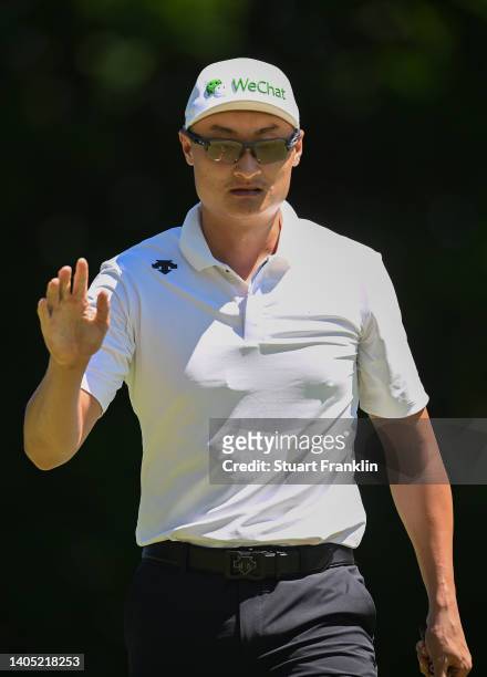 Haotong Li of China acknowledges fans following a birdie on the 3rd hole during Day Four of the BMW International Open at Golfclub Munchen Eichenried...