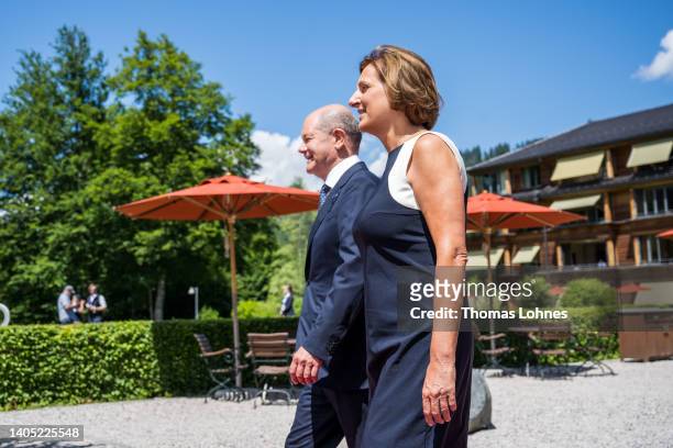 German Chancellor Olaf Scholz and his wife Britta Ernst walk together at Schloss Elmau on the first day of the three-day G7 summit on June 26, 2022...