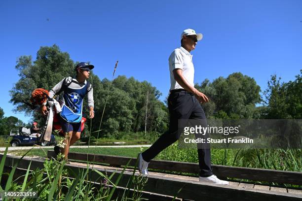 Haotong Li of China walks over a bridge on the 12th hole during Day Four of the BMW International Open at Golfclub Munchen Eichenried on June 26,...