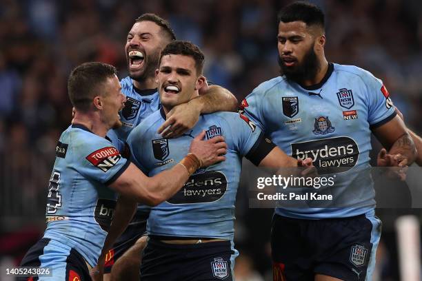 Nathan Cleary of the Blues celebrates a try with Damien Cook and James Tedesco during game two of the State of Origin series between New South Wales...