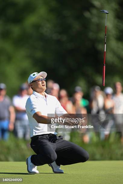 Haotong Li of China throws their putter in reaction following putting on the 18th green during Day Four of the BMW International Open at Golfclub...
