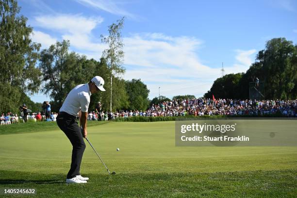 Haotong Li of China chips the ball for their third shot on the 18th hole during Day Four of the BMW International Open at Golfclub Munchen Eichenried...