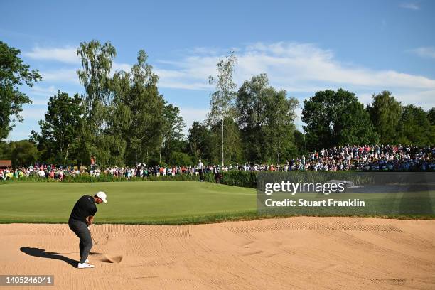 Thomas Pieters of Belgium plays out of a bunker for their third shot on the 18th hole during Day Four of the BMW International Open at Golfclub...