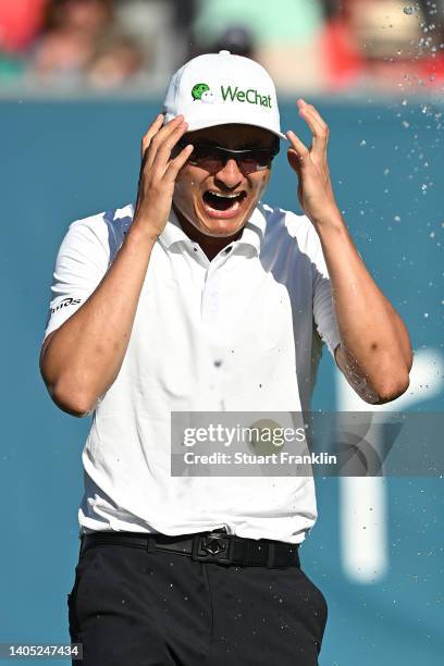 Haotong Li of China celebrates on the 18th hole following the playoff during Day Four of the BMW International Open at Golfclub Munchen Eichenried on...