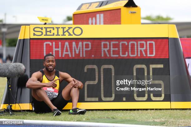 Nethaneel Mitchell Blake of Newhan & Essex Beagles AC poses with his official race time as win the Men's 200m Final during the Muller UK Athletics...