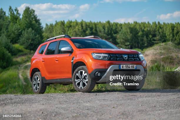 dacia duster on a road - feather duster stock pictures, royalty-free photos & images