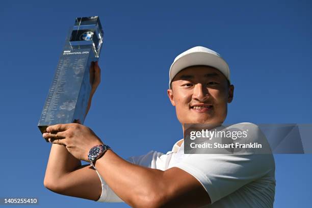 Haotong Li of China poses with the winner's trophy following Day Four of the BMW International Open at Golfclub Munchen Eichenried on June 26, 2022...