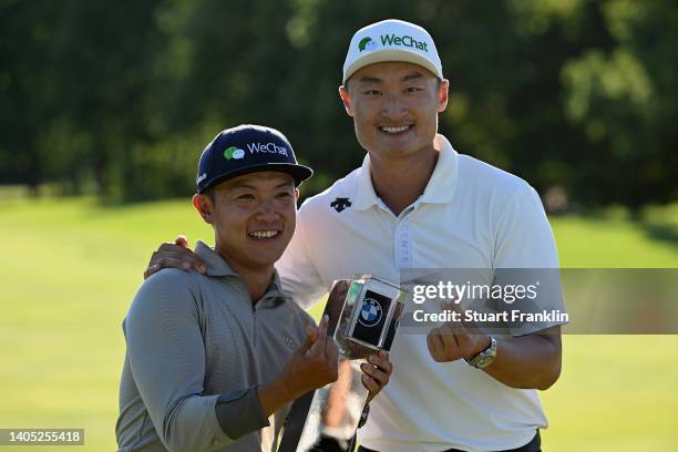 Haotong Li of China and their caddie pose with the winner's trophy following Day Four of the BMW International Open at Golfclub Munchen Eichenried on...