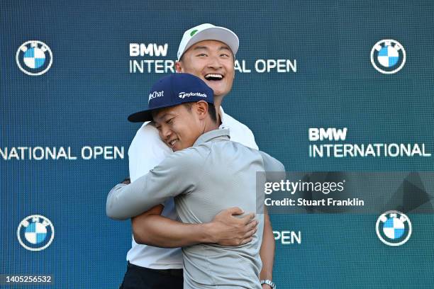 Haotong Li of China and their caddie embrace in celebration following victory in Day Four of the BMW International Open at Golfclub Munchen...