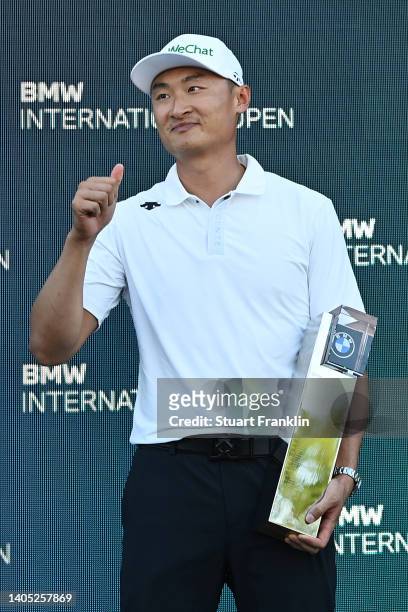 Haotong Li of China poses with the winner's trophy following Day Four of the BMW International Open at Golfclub Munchen Eichenried on June 26, 2022...