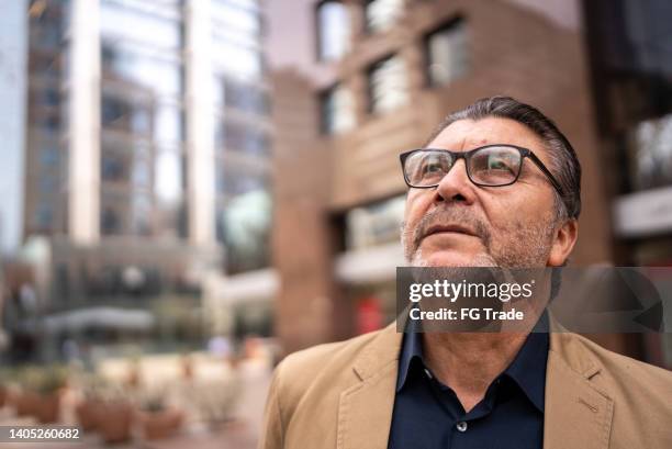 senior businessman contemplating outdoors - chilean ethnicity stock pictures, royalty-free photos & images