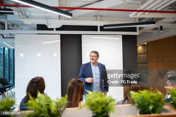 businessman doing a presentation in the conference room - cfo stock pictures, royalty-free photos & images