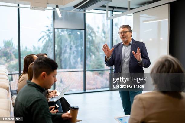 businessman doing a presentation in the conference room - wat stockfoto's en -beelden
