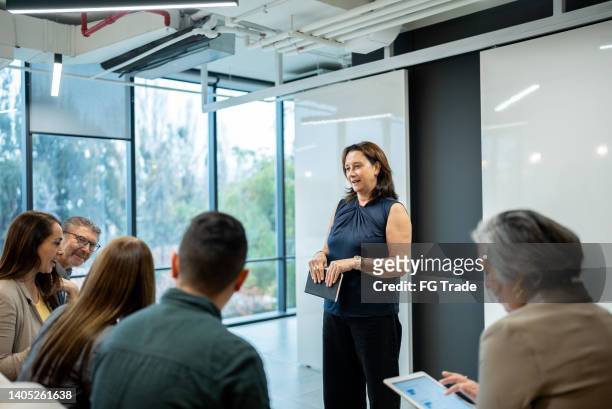 businesswoman doing a presentation in the conference room - chief financial officers stock pictures, royalty-free photos & images