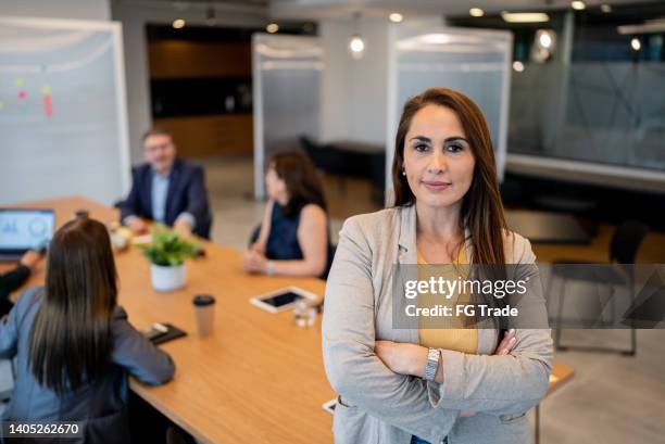 portrait of a business woman during a meeting - chief financial officers stock pictures, royalty-free photos & images