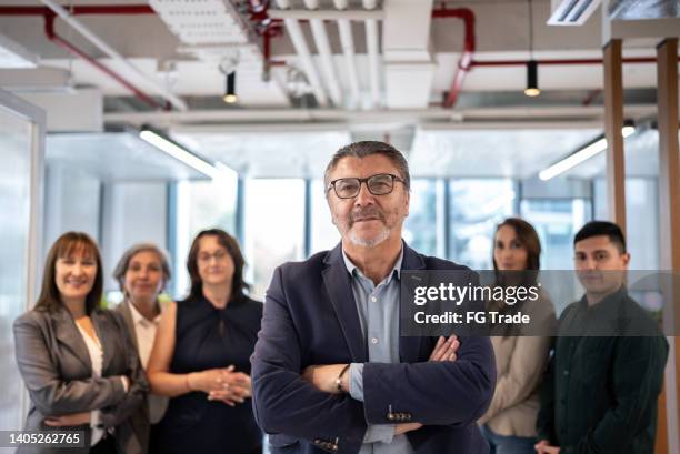 portrait of businessman and team in the office - cfo stock pictures, royalty-free photos & images