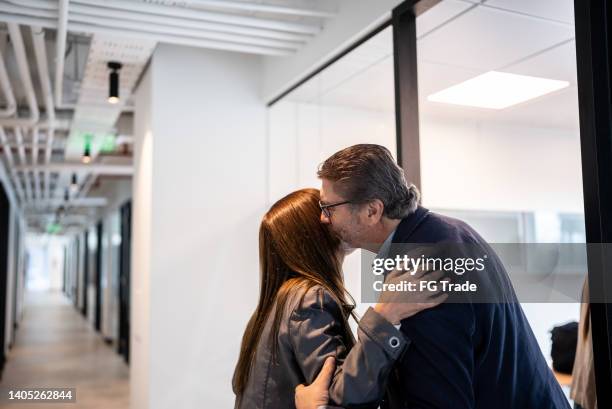 senior businessman greeting employee in the office - pecking stock pictures, royalty-free photos & images