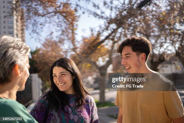 family talking outdoors - buren stockfoto's en -beelden