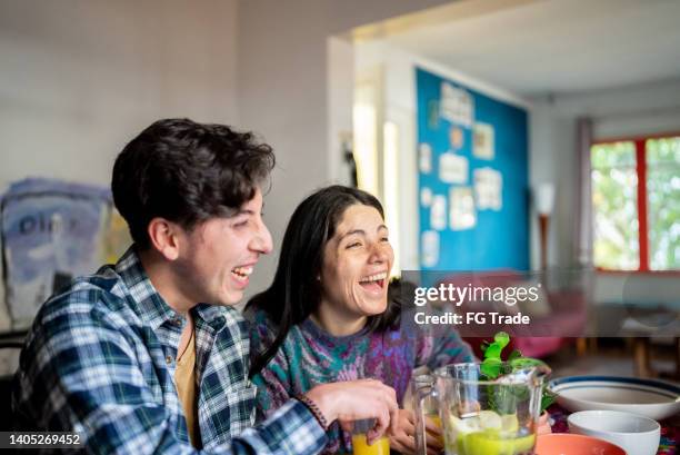 siblings talking and eating at home - chilean ethnicity stock pictures, royalty-free photos & images