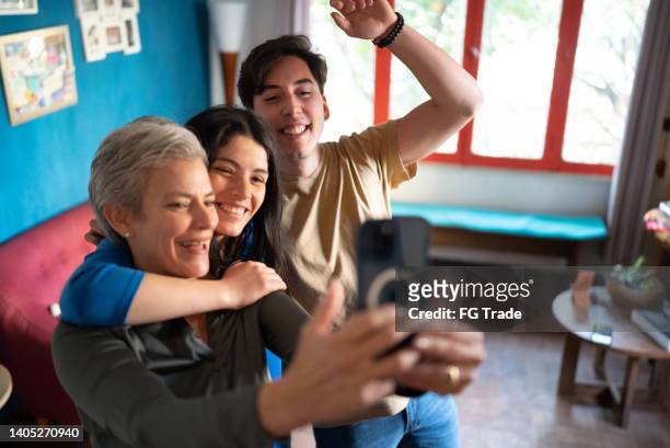 family taking selfies on the mobile phone at home - no 2012 chilean film stockfoto's en -beelden