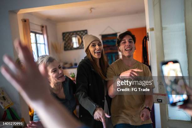 family dancing and singing while being filmed or photographed at home - no 2012 chilean film stockfoto's en -beelden