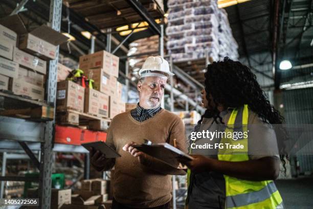warehouse inspector and manager doing an informal meeting - elderly receiving paperwork stock pictures, royalty-free photos & images