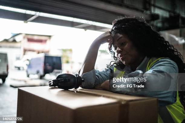 tired or worried female warehouse worker - mistaken identity stock pictures, royalty-free photos & images