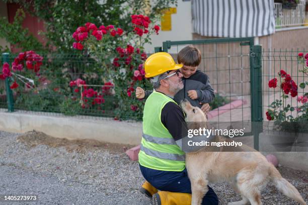 the engineer goes to night shift and says goodbye to his child at the entrance of the house. - dog greeting stock pictures, royalty-free photos & images