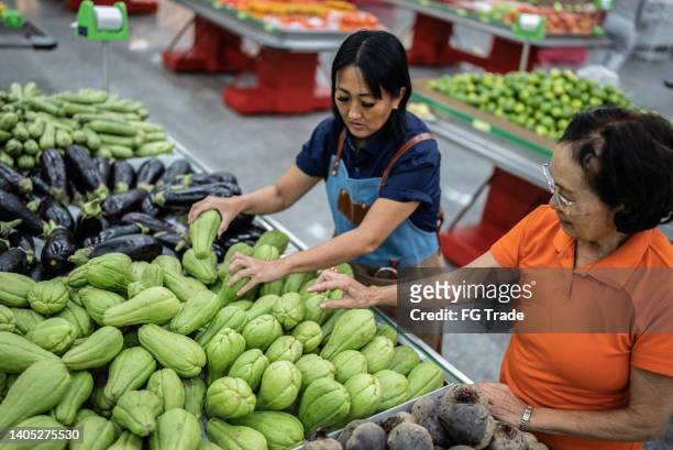 family business working together in a supermarket - arranging stock pictures, royalty-free photos & images