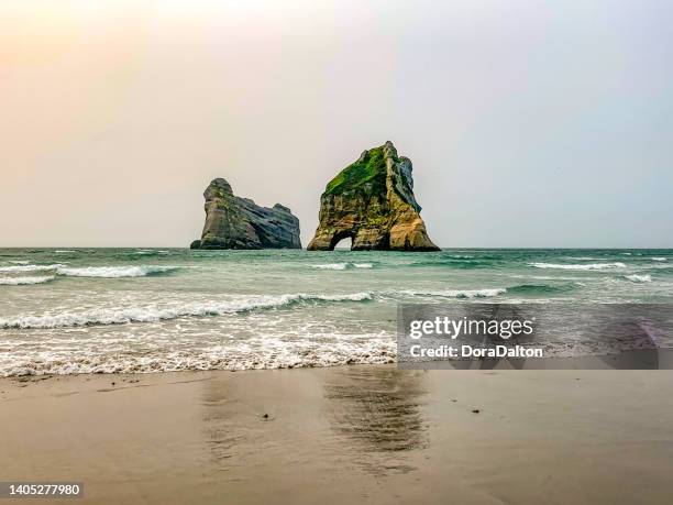 wharariki beach and archway islands view, golden bay, south island, new zealand - tasman stock pictures, royalty-free photos & images