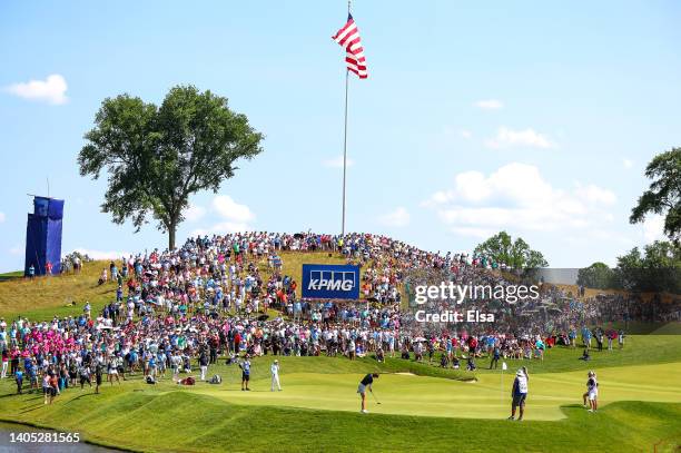 In Gee Chun of South Korea putts on the 18th green as a gallery of fans look on during the final round of the KPMG Women's PGA Championship at...