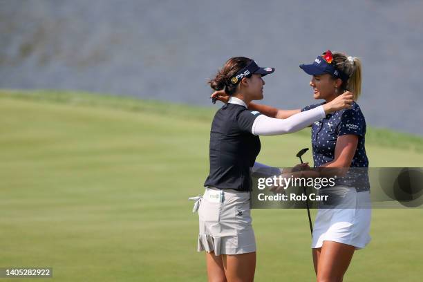 Lexi Thompson of the United States congratulates In Gee Chun of South Korea on her win on the 18th green during the final round of the KPMG Women's...